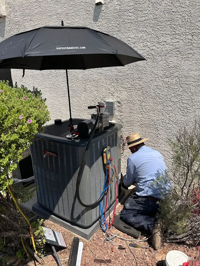HVAC technician performing outdoor AC maintenance in Dover